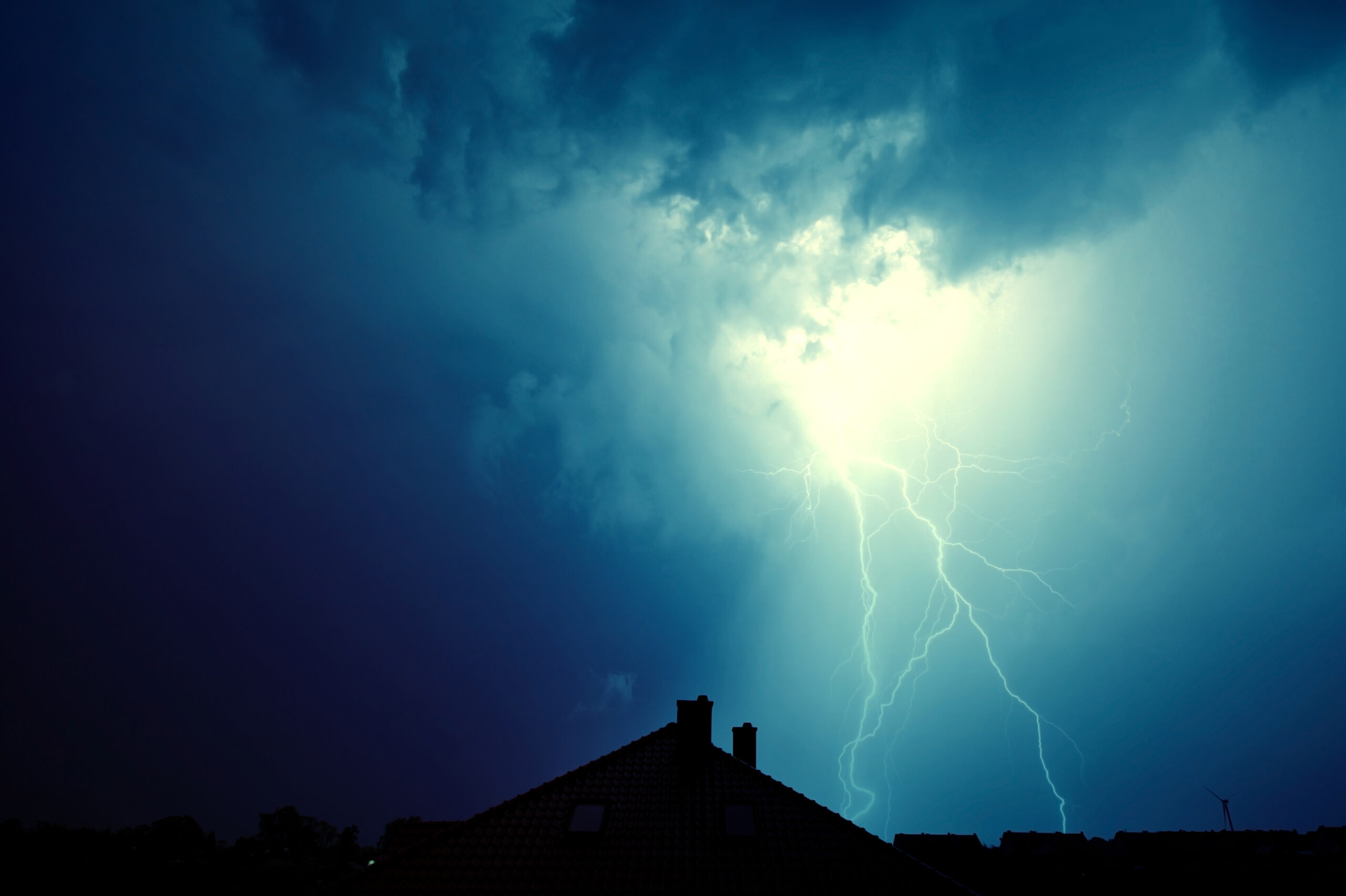 Dramatic sky and storm. Lightning hit the house. Power of nature concept.